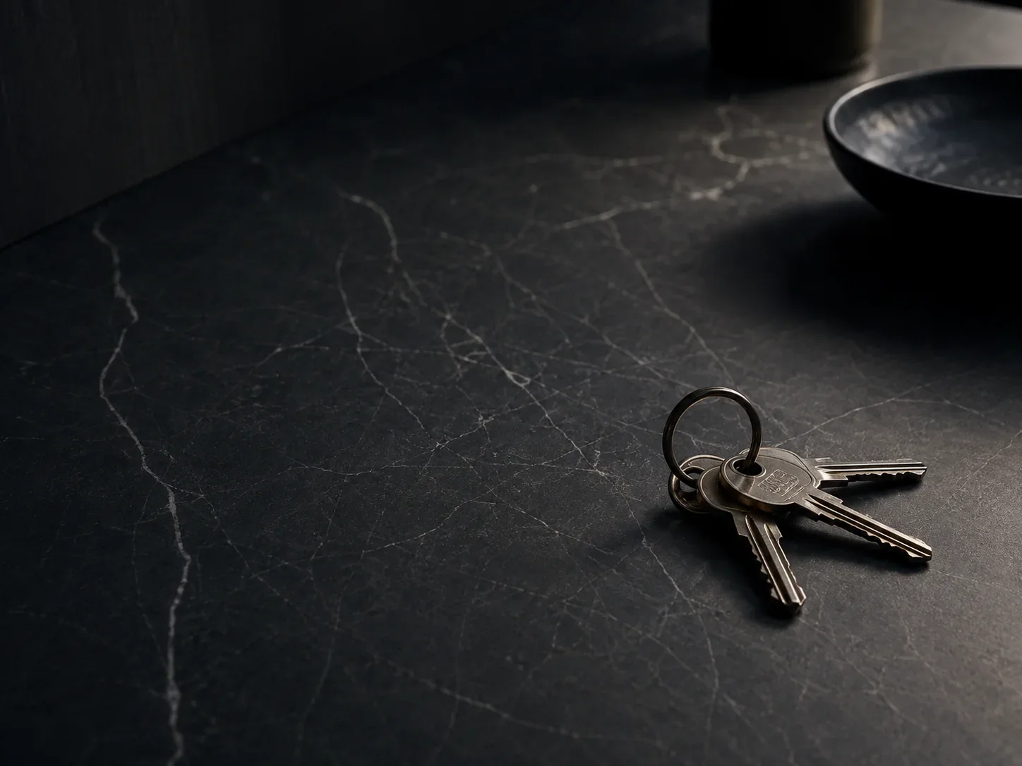 Keys resting on a durable dark stone surface